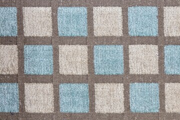 Closeup shot of a blue brown square patterned fabric textile surface