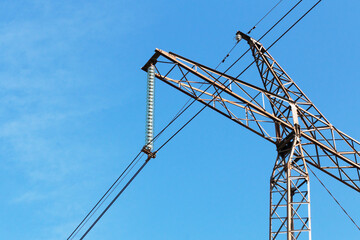 Electricity. Element of power transmission tower against the blue sky.