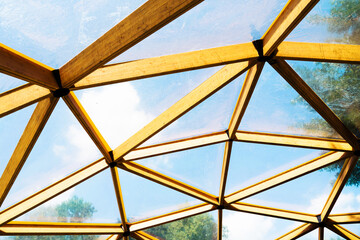 Wooden dome with a transparent roof. The design of the ceiling in the gazebo or veranda. Close up