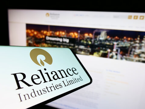 Stuttgart, Germany - 09-22-2022: Mobile phone with logo of Indian company Reliance Industries Limited on screen in front of website. Focus on center-right of phone display.