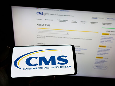 Stuttgart, Germany - 09-22-2022: Person Holding Smartphone With Logo Of Centers For Medicare And Medicaid Services (CMS) On Screen In Front Of Website. Focus On Phone Display.