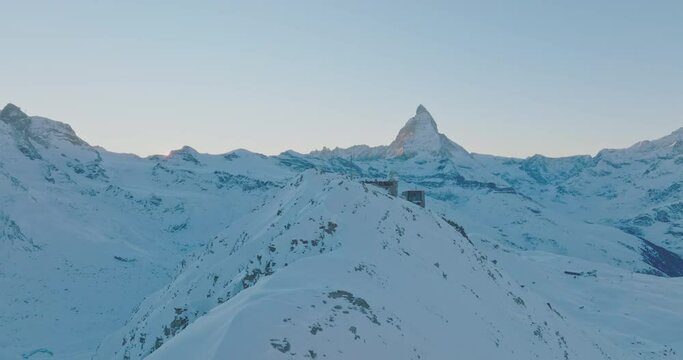 Aerial drone flyover Gornergrat with Matterhorn view during winter in Switzerland. Majestic mountain peaks iconic famous zermatt travel ski resort in the alps. Wonderful inspiring nature landscape.
