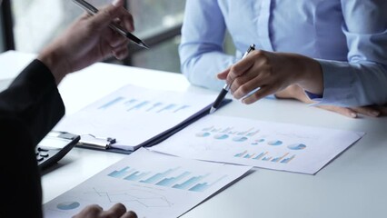 Business team two colleagues discussing new plan financial graph data on office table with laptop and digital tablet.