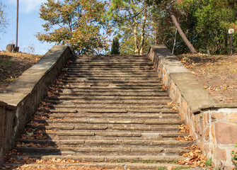 Fototapeta na wymiar Stone paved stairs in park, in autumn