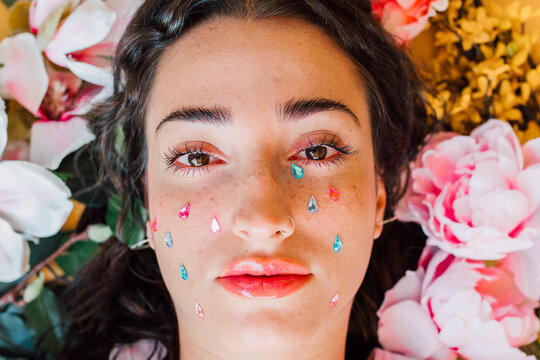 Sad young woman with teardrop stickers on cheeks
