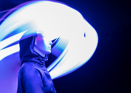 AI robot standing amidst light trail in dark