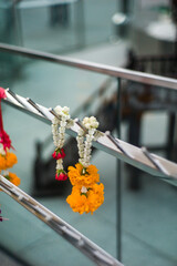 Thai garland hanging on metal fence