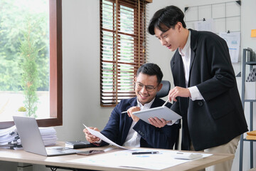 Two Business working at office with documents on desk, meeting to planning analyzing the financial report, business plan investment, finance analysis concept © wichayada