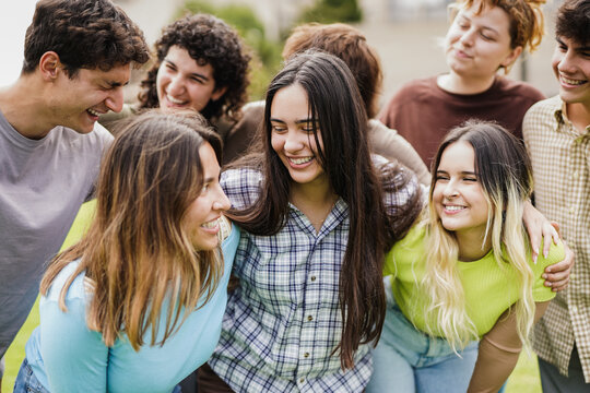 Diverse young people having fun outdoor - Cheerful students outside of university
