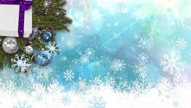 Animation of snow falling over christmas baubles