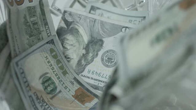 100 Dollar Bills Fall, Drop Into Crystal Bowl Close Up