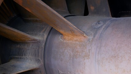 Close-up of a jet engine combustion chamber made of titanium and heat-resistant steel. Engine for...