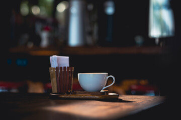Latte coffee mugs on wooden table in a cafe, beautiful with natural light, vintage tones, food and drink.