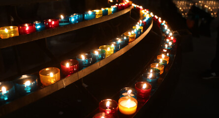 candles of various colors in the church for the prayers