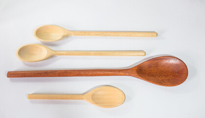 Close up and top view of wooden spoons on white background.