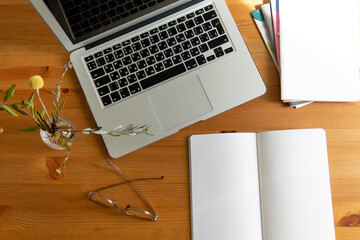 business background. glasses laptop and notebooks white and gray. notebook in a cage on a beautiful...