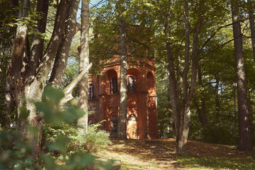 Lentvaris manor homestead tower built from red bricks between the trees