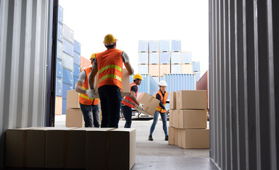 Men worker loading cardboard boxes into containers, Warehousing and logistic shipping cargo concept - 533714552