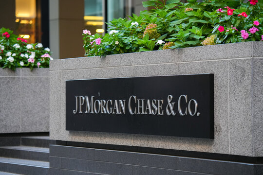 The logo sign of JPMorgan Chase brand, an American multinational investment bank and financial services, in front of the headquarters from New York, 2022.