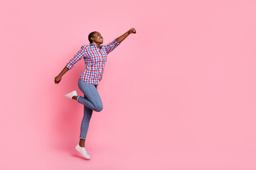 Fototapeta na wymiar Full length profile photo of sportive active person raise hand fist jump fly empty space isolated on pink color background