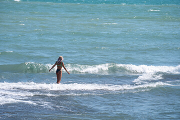 Fototapeta premium Blonde in a bikini in the se