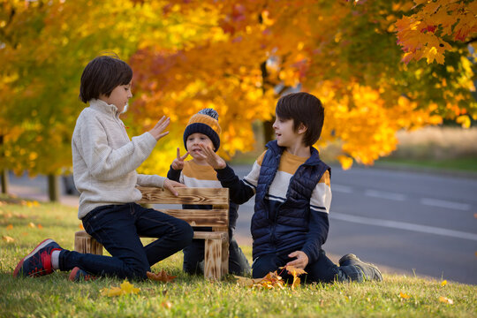 Happy family, mother with children, having their autumn pictures taken in the park