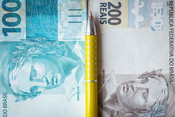 financial settlements in brazil, concept, 100 and 200 reais banknotes stacked nicely side by side,...