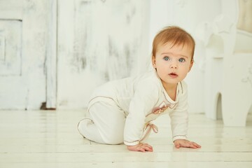 Fototapeta premium A small newborn baby is in a bright room. The concept of childhood