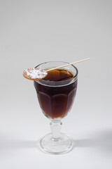 brown cube libre cocktail with cola, brandy or rum or whiskey isolated on white
