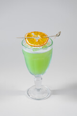 fresh green cocktail with pisang liquor and orange isolated