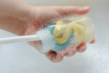 Washing baby bottle. Mother's hand washing the baby bottle..