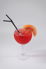 red grapefruit juicy cocktail isolated with straw