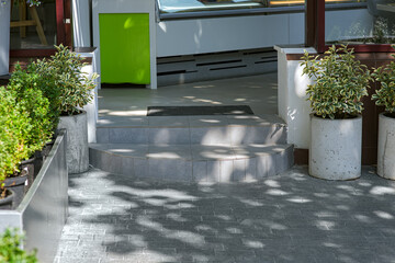 ceramic tile round threshold doorstep store entrance with door mat by pedestrian pavement of...