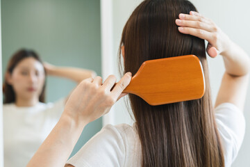 Health hair care, beauty makeup asian woman, girl holding hairbrush and brushing, combing her long...