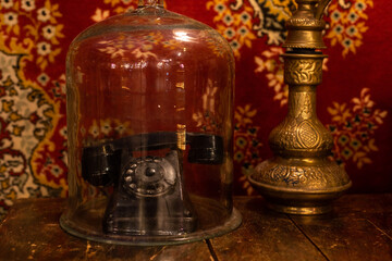 Fototapeta na wymiar Retro telephone on table in front carpet background