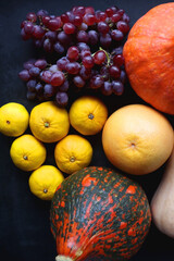 Various fresh and healthy autumnal fruit and vegetable. Top view, dark background.