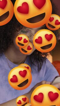 Young adult black female receiving emoticon love on smart phone
