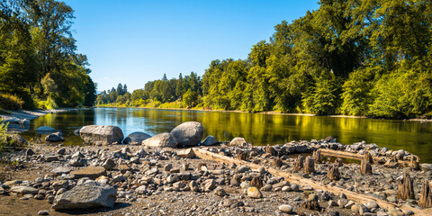 Autumn Rogue River and Riverside park forest landscape over the rocky beach with ruined pilings in Grants Pass, Oregon - obrazy, fototapety, plakaty
