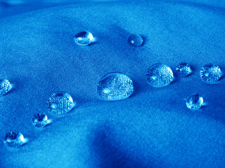Technological blue waterproof and breathable fabric with raindrops