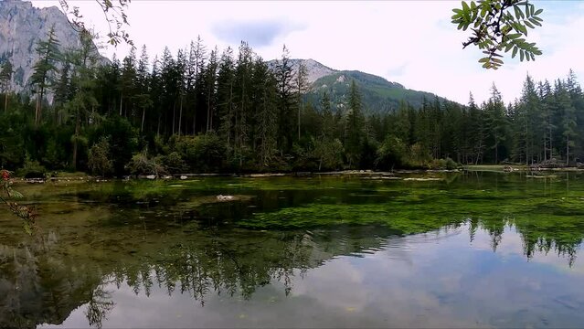 Panoramic view on alpine lake Kreuzteich near Green Lake (Gruener See) in Hochschwab mountain region, Styria, Austria, Europe. Reflection of mountain peaks Messnerin and Pribitz in crystal clear water