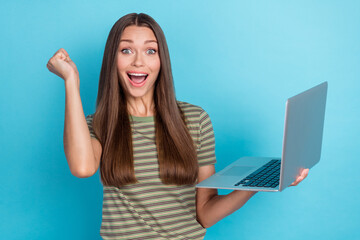Photo of young adorable cute gorgeous nice woman wear t-shirt hold computer fist up excited...