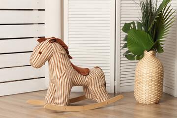 Brown rag horse for a rocking chair in the interior