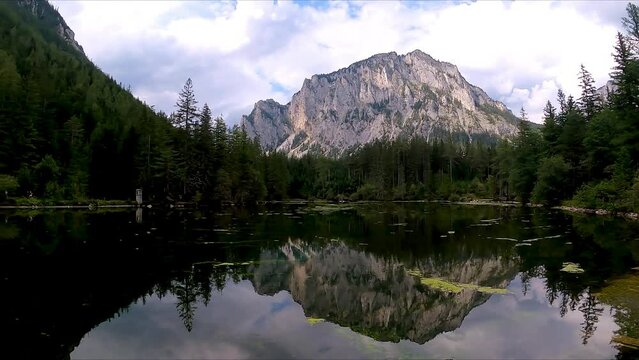 Panoramic view on alpine lake Kreuzteich near Green Lake (Gruener See) in Hochschwab mountain region, Styria, Austria, Europe. Reflection of mountain peaks Messnerin and Pribitz in crystal clear water