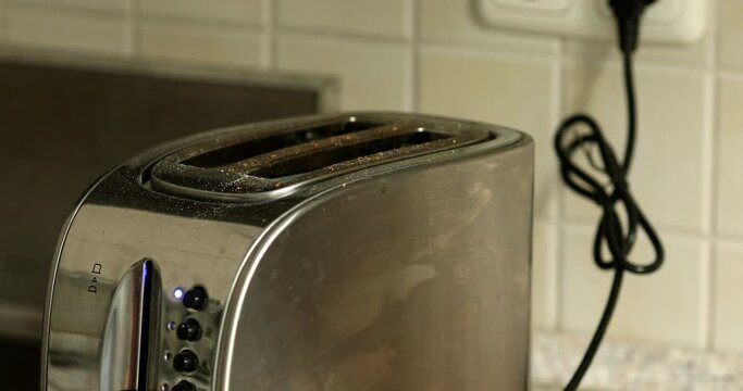 Roasted bread in silver toaster. two delicious and toaster toasts. the process of frying toasts.