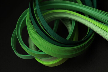 Texture green color strip wave paper on black. Abstract horizontal background.
