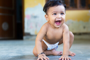 Six months cute child boy laughing out loud on floor
