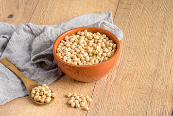 a bowl of chickpeas and others in a wooden spoon