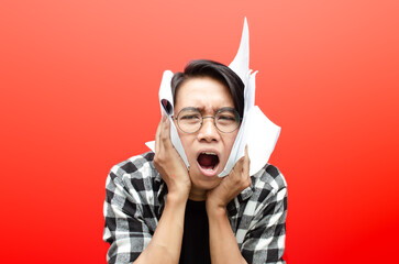 asian man stressed and tired over work while holding blank paper work. angry and tired of asian man...