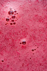 abstract of red color drink or juice surface, close-up macro of beverage or smoothie texture, full frame background