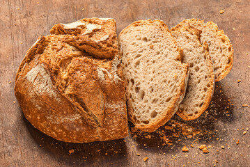 Sliced wholegrain bread on dark ructic wooden background closeup. Fresh bread Top view. .